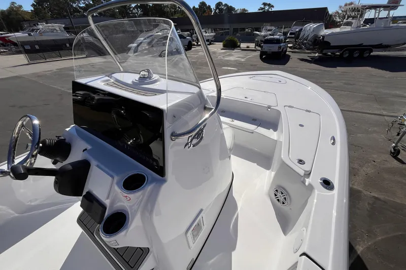 Slide: The Image of 2026 Tidewater 2110 Bay Max boat with sleek console and spacious deck in a marina setting. - 6