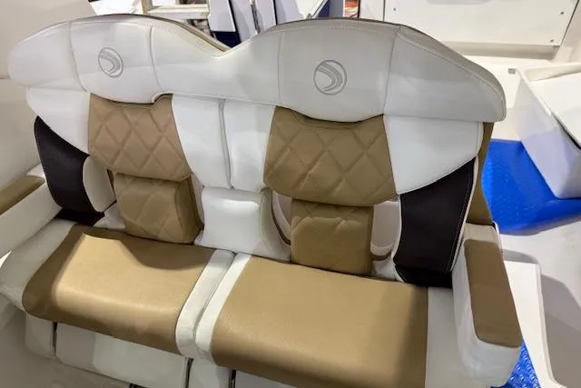 Slide: The Image of 2020 Edgewater 262CX Crossover boat seats with tan and white upholstery, featuring quilted design. - 10
