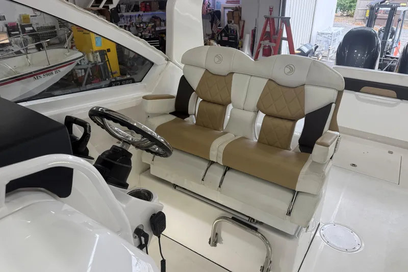 Slide: The Image of 2020 Edgewater 262CX Crossover boat interior with dual captain's seats and steering wheel. - 11