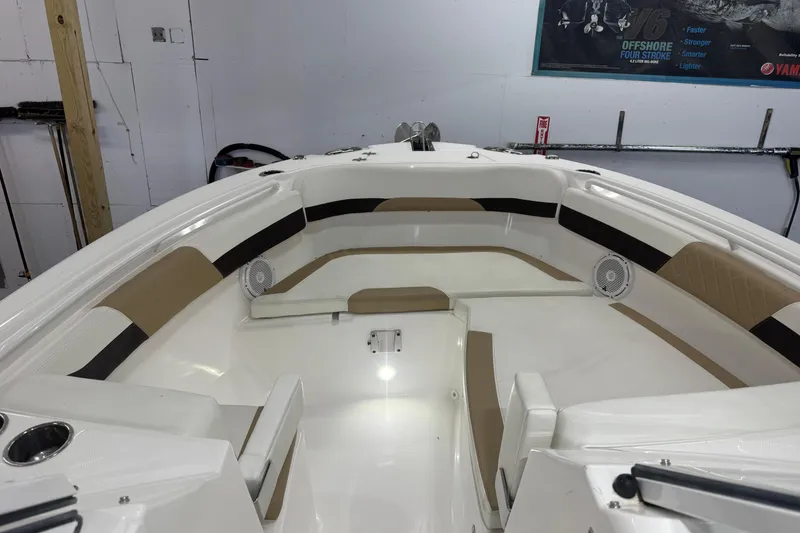 Slide: The Image of 2020 Edgewater 262CX Crossover boat interior with beige and white seating. - 23
