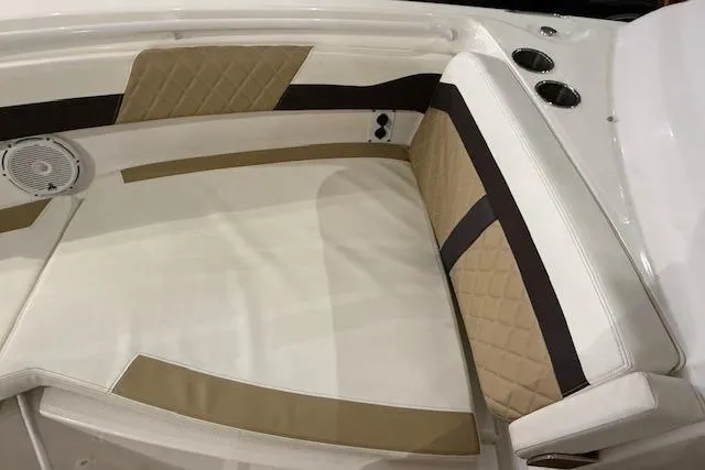 Slide: The Image of 2020 Edgewater 262CX Crossover boat interior with tan and white cushioned seating. - 24