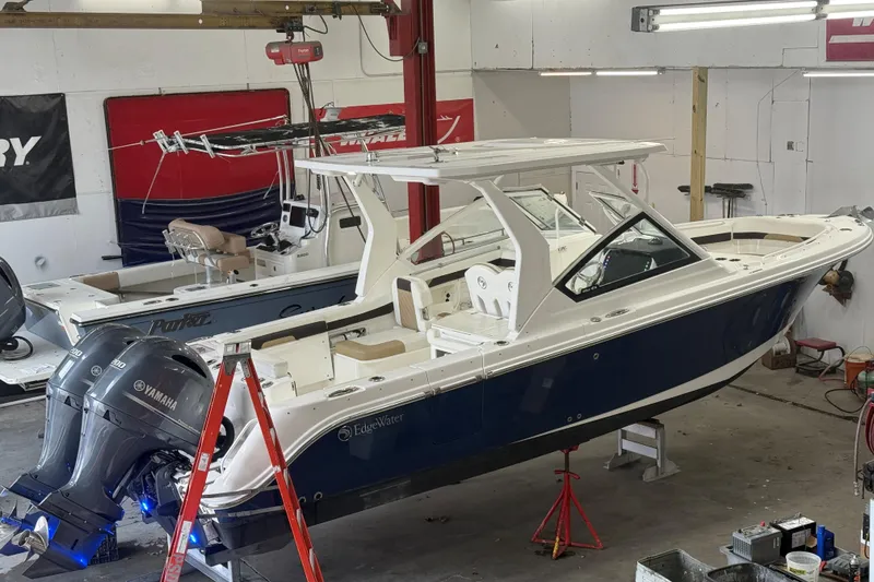 Slide: The Image of 2020 Edgewater 262CX Crossover boat in a workshop with Yamaha engines. - 3