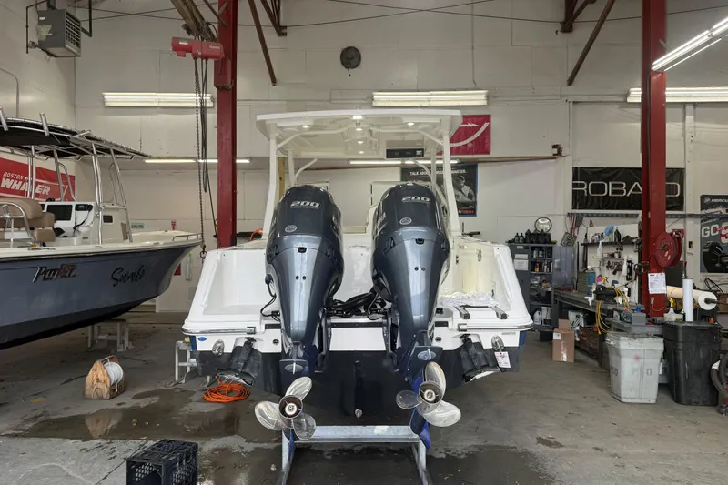 Slide: The Image of 2020 Edgewater 262CX Crossover boat in a workshop with dual Yamaha engines. - 5