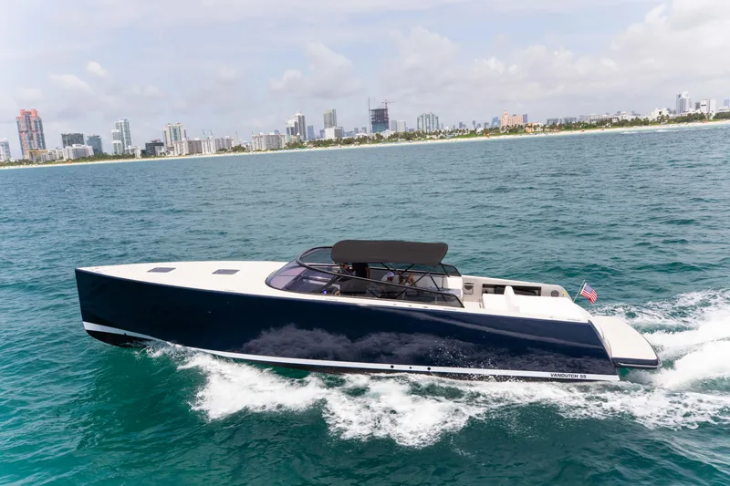 The Image of 2017 VanDutch 55 yacht cruising on ocean near city skyline. - 0