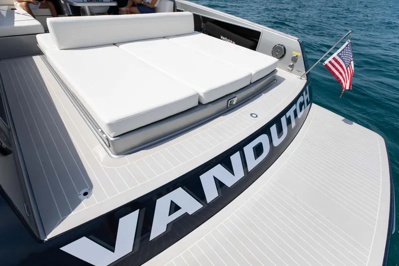 Slide: The Image of VanDutch 55 yacht, 2017 model, featuring a spacious sun deck and American flag on open water. - 14