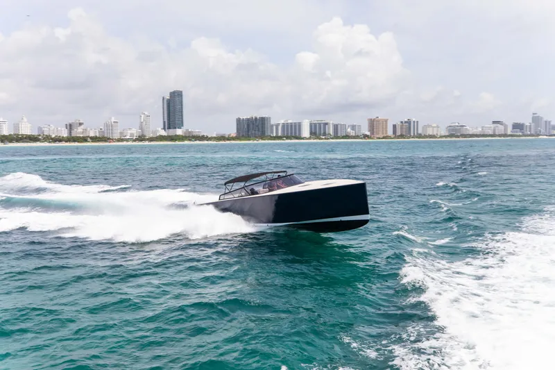 Slide: The Image of VanDutch 55 yacht cruising on ocean near city skyline, 2017 model. - 21