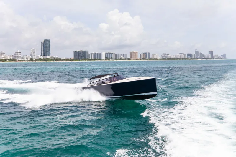 Slide: The Image of 2017 VanDutch 55 yacht cruising on ocean near city skyline. - 22