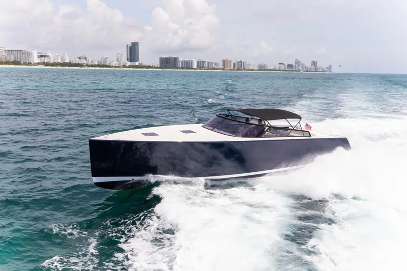 Slide: The Image of VanDutch 55 yacht cruising on ocean near city skyline, 2017 model. - 25