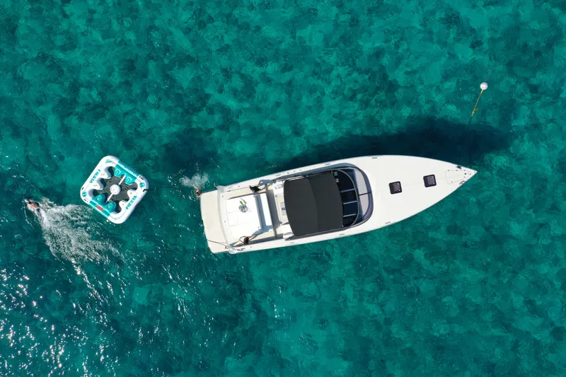 Slide: The Image of Aerial view of 2017 VanDutch 55 yacht on clear turquoise water. - 29