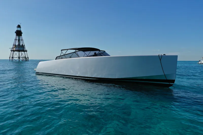 Slide: The Image of 2017 VanDutch 55 yacht on clear blue water near a lighthouse. - 30