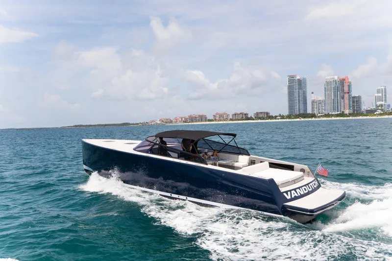 Slide: The Image of VanDutch 55 yacht cruising near a city skyline, 2017 model. - 4