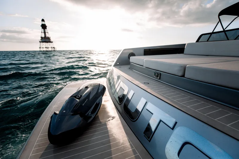 Slide: The Image of VanDutch 55 yacht on ocean at sunset, 2017 model, with distant lighthouse. - 7