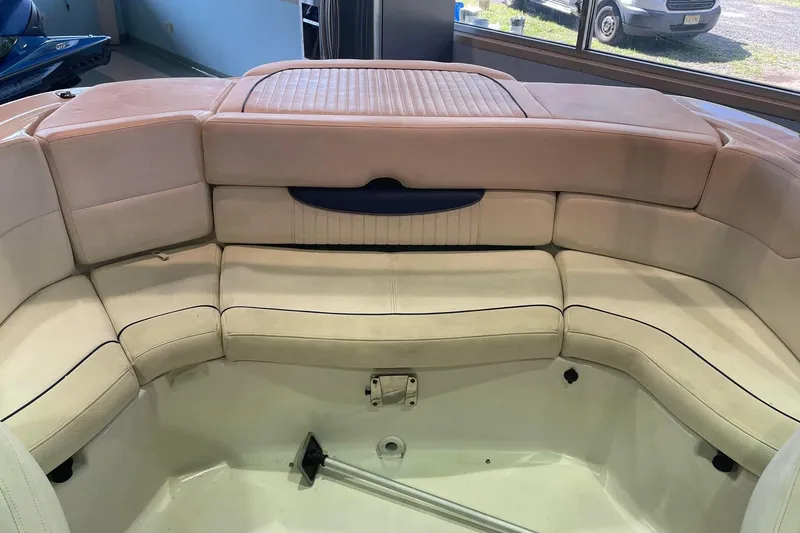 Slide: The Image of 2008 Monterey 214FS boat interior with beige seating and storage compartment. - 7