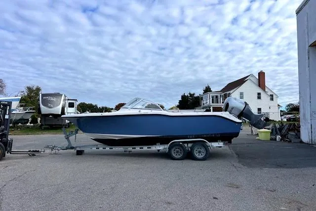 Slide: The Image of 2020 Key West 239 DFS boat on trailer, parked outdoors under cloudy sky. - 16