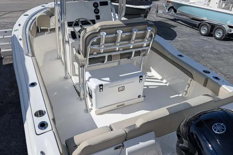 Slide: The Image of 2026 Key West 219 FS boat interior with seating and console, parked on a trailer. - 11