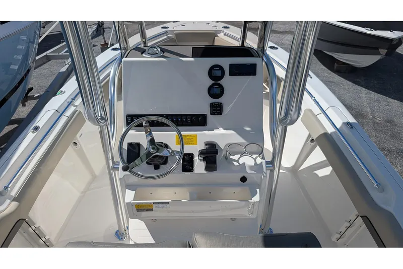 Slide: The Image of 2026 Key West 219 FS boat console with steering wheel and controls. - 13
