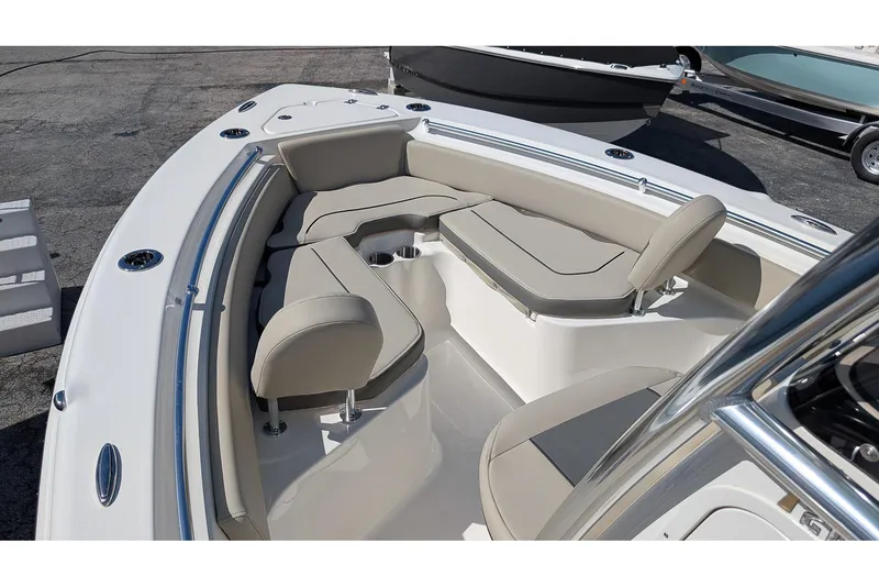 Slide: The Image of 2026 Key West 219 FS boat interior with cushioned seating and cup holders. - 16