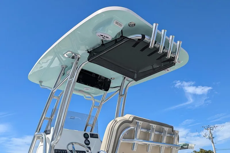 Slide: The Image of 2026 Key West 219 FS boat with T-top and rod holders against blue sky. - 19