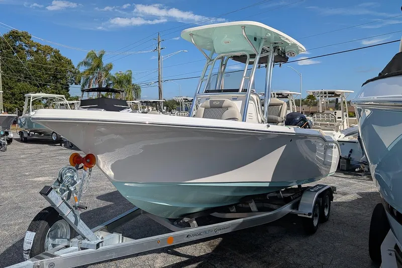 Slide: The Image of 2026 Key West 219 FS boat on trailer, parked outdoors under clear sky. - 3