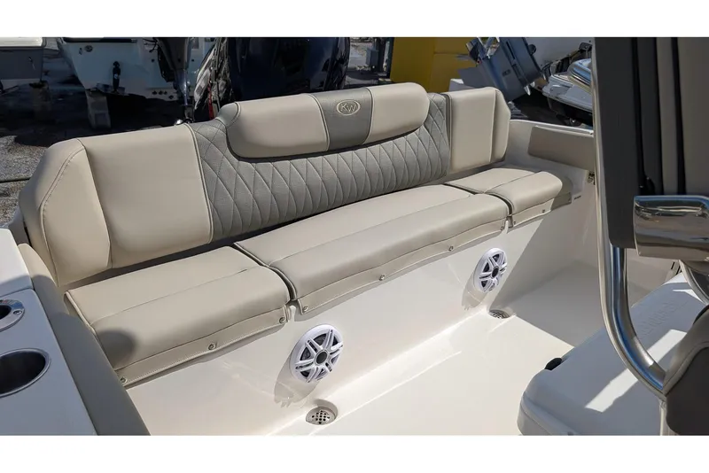 Slide: The Image of 2026 Key West 219 FS boat with beige cushioned seating and built-in speakers. - 8