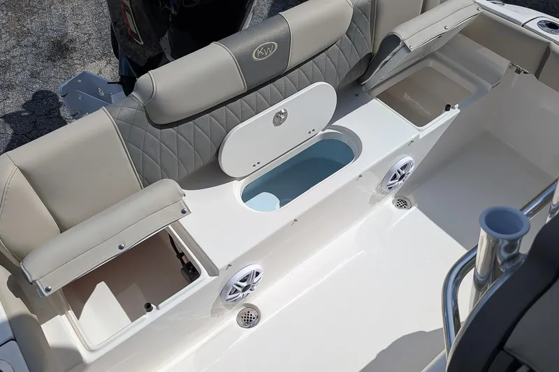 Slide: The Image of 2026 Key West 219 FS boat interior with seating, storage, and speaker system. - 9