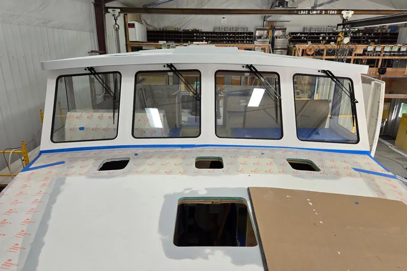 Slide: The Image of 2025 Calvin Beal Sedan under construction in a workshop setting. - 10