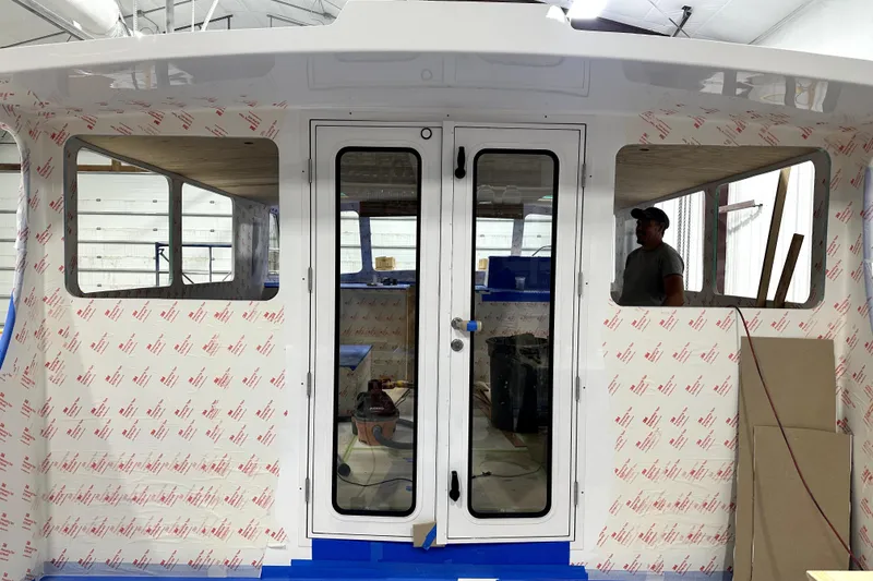 Slide: The Image of 2025 Calvin Beal Sedan under construction, featuring a partially completed cabin interior. - 14
