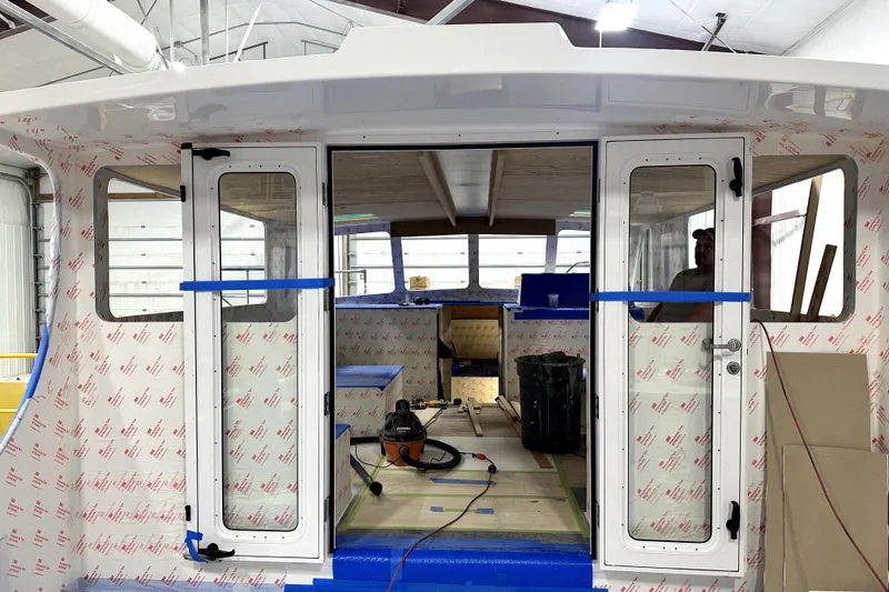 Slide: The Image of Interior view of a 2025 Calvin Beal Sedan boat under construction. - 15