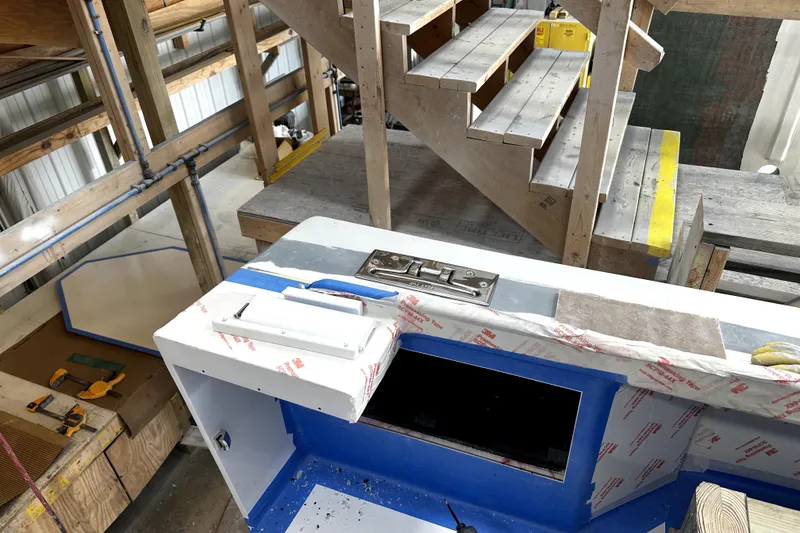 Slide: The Image of Workshop scene with wooden stairs and a partially assembled structure. - 16