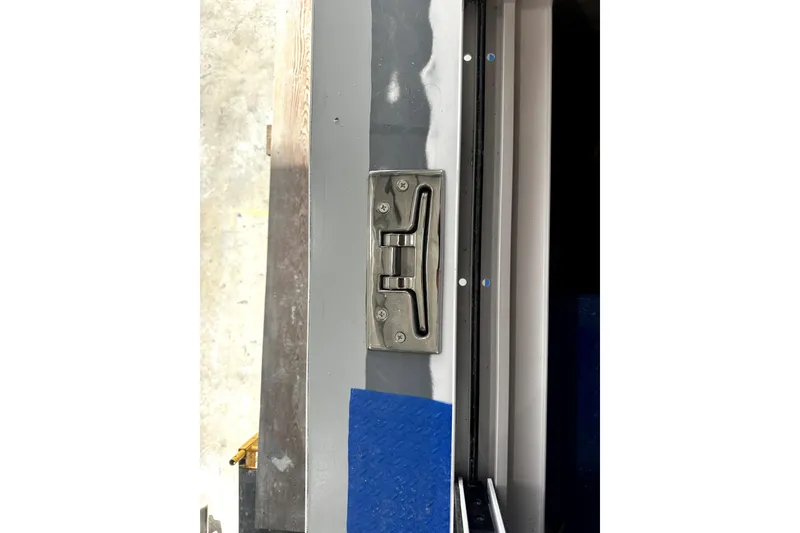 Slide: The Image of Close-up of a metal latch on a 2025 Calvin Beal Sedan door. - 19