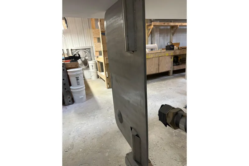 Slide: The Image of Workshop interior with metal panel, possibly part of a 2025 Calvin Beal Sedan. - 24