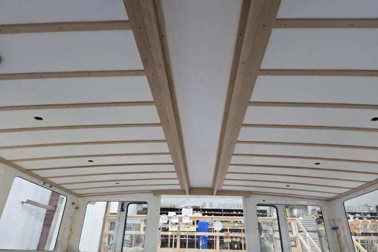 Slide: The Image of Interior view of a 2025 Calvin Beal Sedan, showcasing ceiling design and window layout. - 31