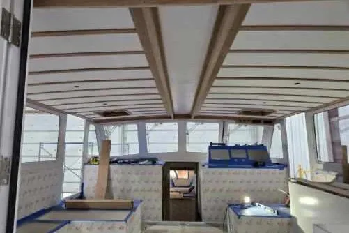 Slide: The Image of Interior view of a 2025 Calvin Beal Sedan boat under construction. - 32