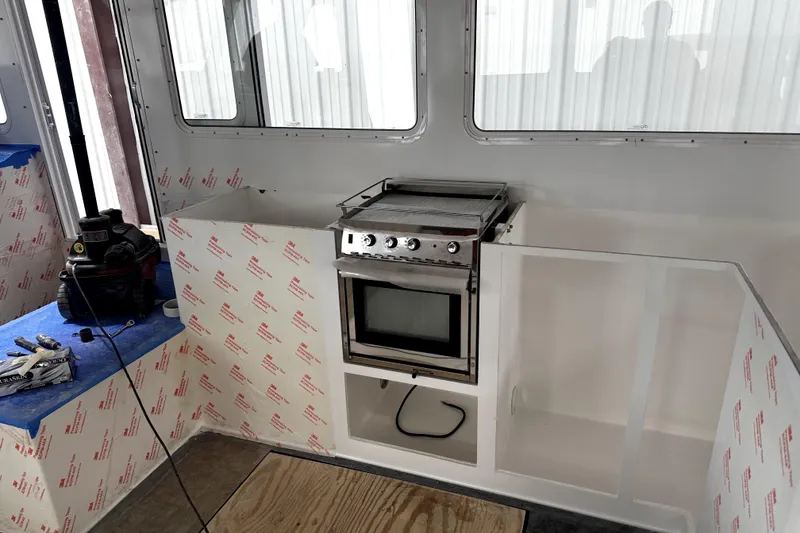 Slide: The Image of Interior of a 2025 Calvin Beal Sedan with a built-in kitchen setup. - 34