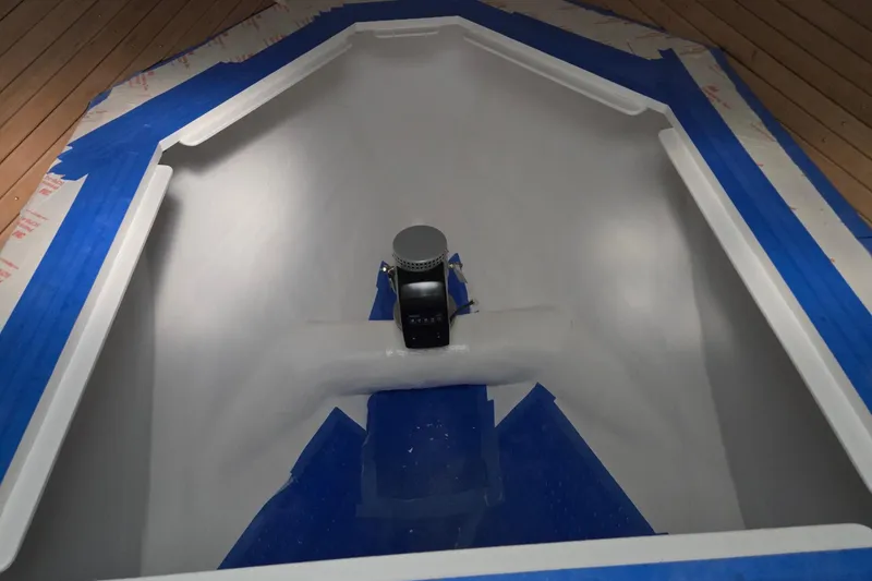 Slide: The Image of Interior view of a 2025 Calvin Beal Sedan boat under construction with blue tape. - 39