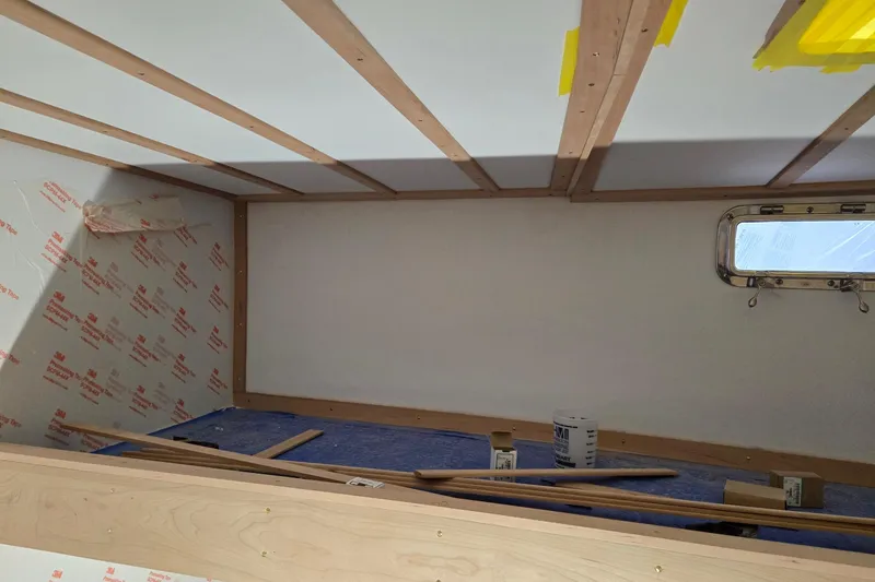 Slide: The Image of Interior construction of 2025 Calvin Beal Sedan, featuring wooden beams and insulation materials. - 43