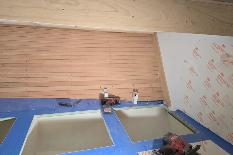 Slide: The Image of Interior construction with wood paneling and tools, Calvin Beal Sedan 2025. - 46