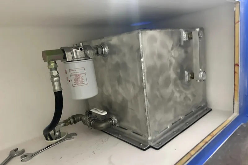 Slide: The Image of Fuel system component in a 2025 Calvin Beal Sedan, featuring a metal tank and filter. - 52