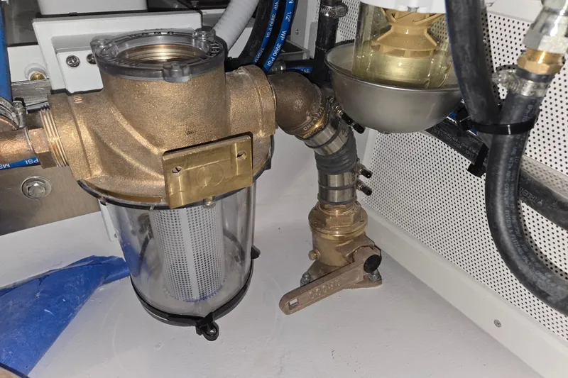 Slide: The Image of Engine compartment of a 2025 Calvin Beal Sedan, showcasing fuel filtration system components. - 53