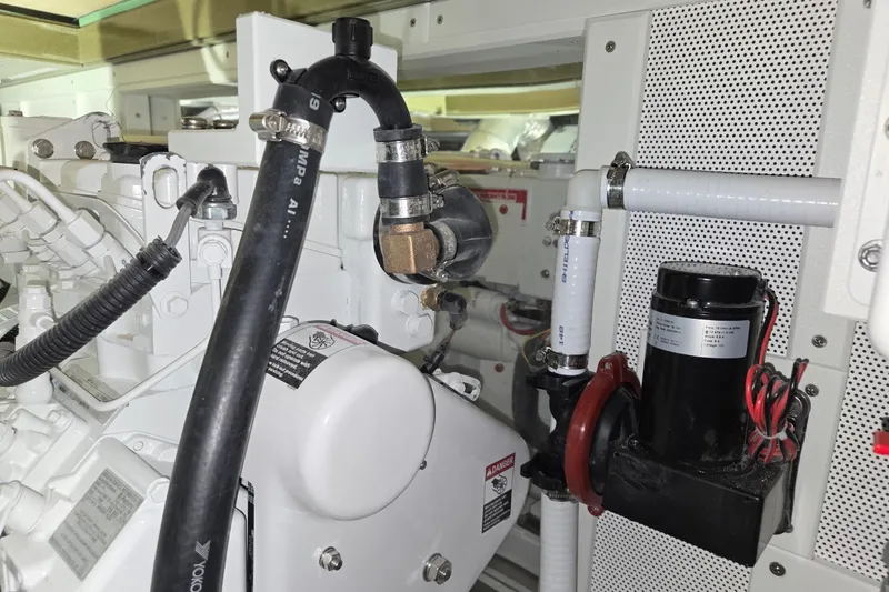 Slide: The Image of Engine compartment of a 2025 Calvin Beal Sedan, showcasing hoses and mechanical components. - 57