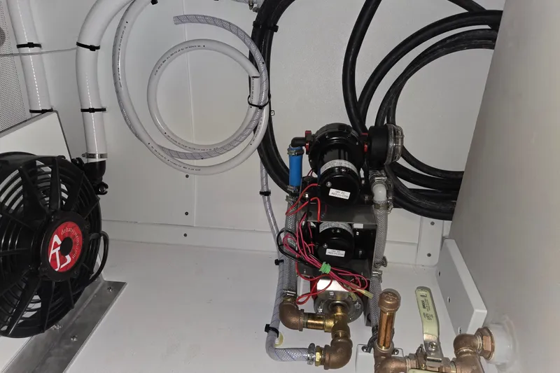 Slide: The Image of 2025 Calvin Beal Sedan engine compartment with wiring and cooling system components. - 59