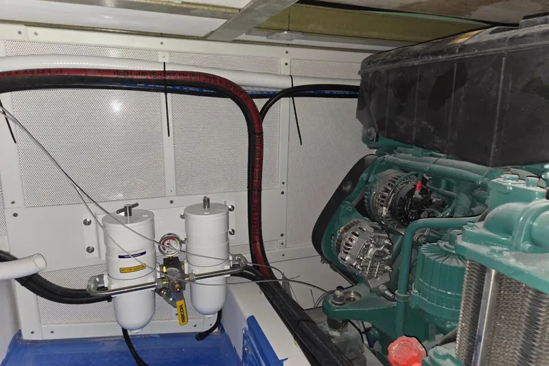 Slide: The Image of Engine compartment of a 2025 Calvin Beal Sedan with visible components and wiring. - 60