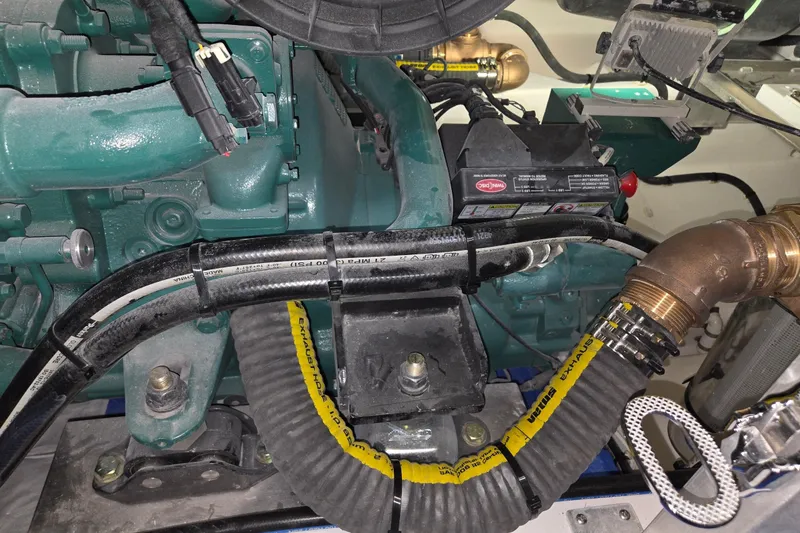 Slide: The Image of Engine compartment of a 2025 Calvin Beal Sedan, showcasing various hoses and components. - 62