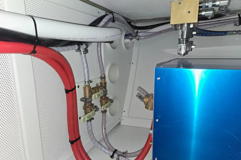 Slide: The Image of Engine compartment of a 2025 Calvin Beal Sedan with visible wiring and components. - 69