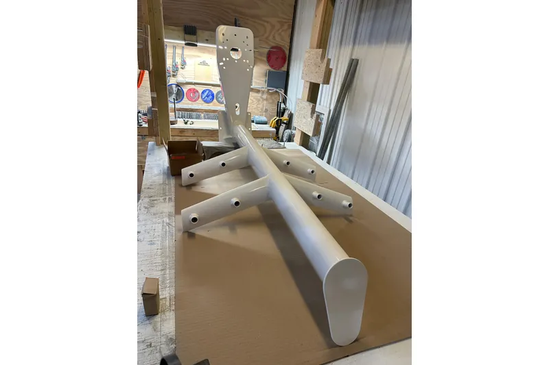 Slide: The Image of White metal frame in workshop, possibly part of 2025 Calvin Beal Sedan assembly. - 7