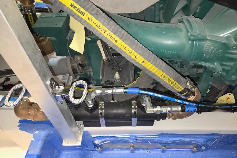 Slide: The Image of Engine compartment of a 2025 Calvin Beal Sedan with visible hoses and components. - 71