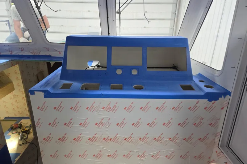 Slide: The Image of Interior view of a 2025 Calvin Beal Sedan under construction, featuring a blue dashboard. - 77