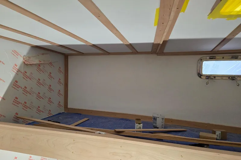 Slide: The Image of Interior construction of a 2025 Calvin Beal Sedan, featuring wood paneling and insulation materials. - 79