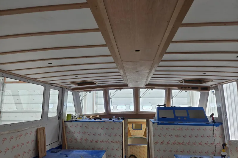 Slide: The Image of Interior view of a 2025 Calvin Beal Sedan boat under construction. - 82