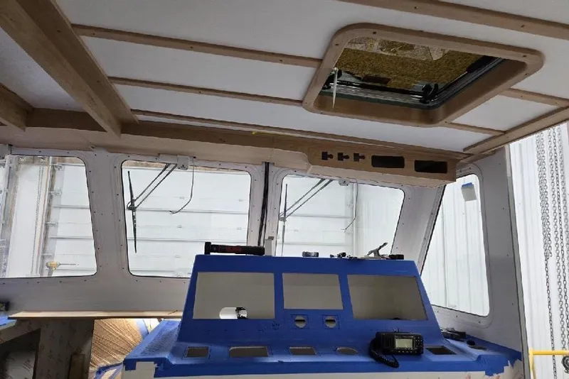 Slide: The Image of Interior view of a 2025 Calvin Beal Sedan boat with a blue control panel. - 84
